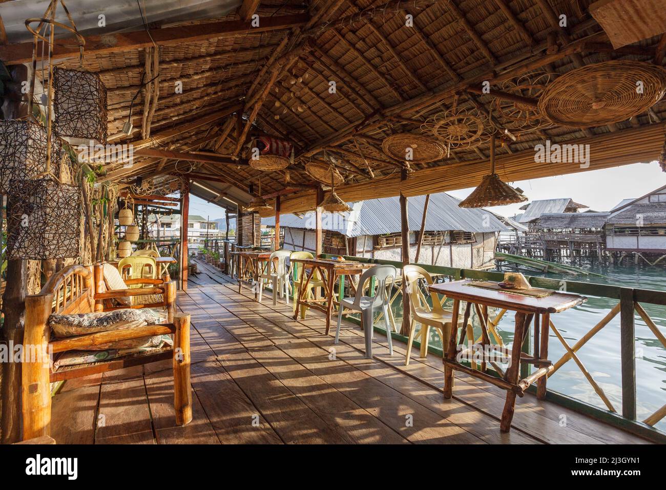 Philippines, Palawan, Calamianes archipelago, Coron Town, Krystal Lodge charming hotel, on stilts and made of natural materials, terrace bathed in late afternoon warm light Stock Photo