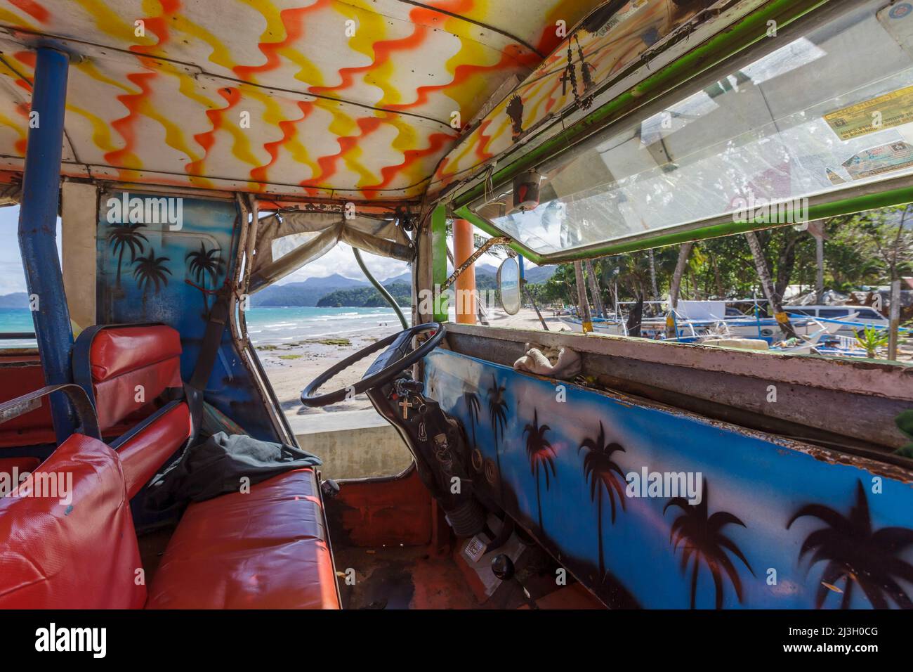Philippines, Palawan, Sabang Beach, colorful interior of a jeepney on the sunny beach Stock Photo