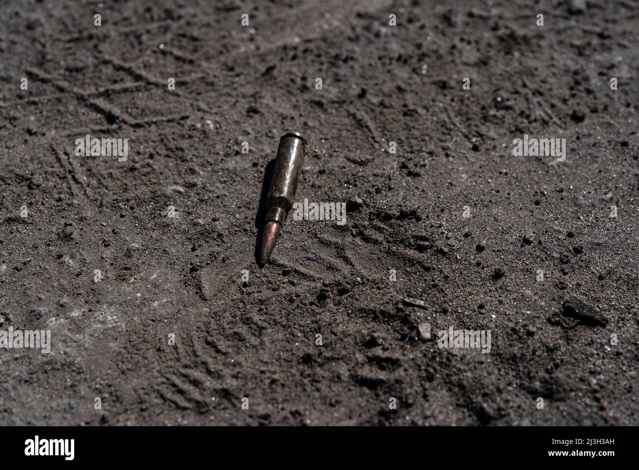 BUCHA, UKRAINE - APRIL 7, 2022 - A cartridge lies on the ground after the liberation of the city from Russian invaders, Bucha, Kyiv Region, northern U Stock Photo