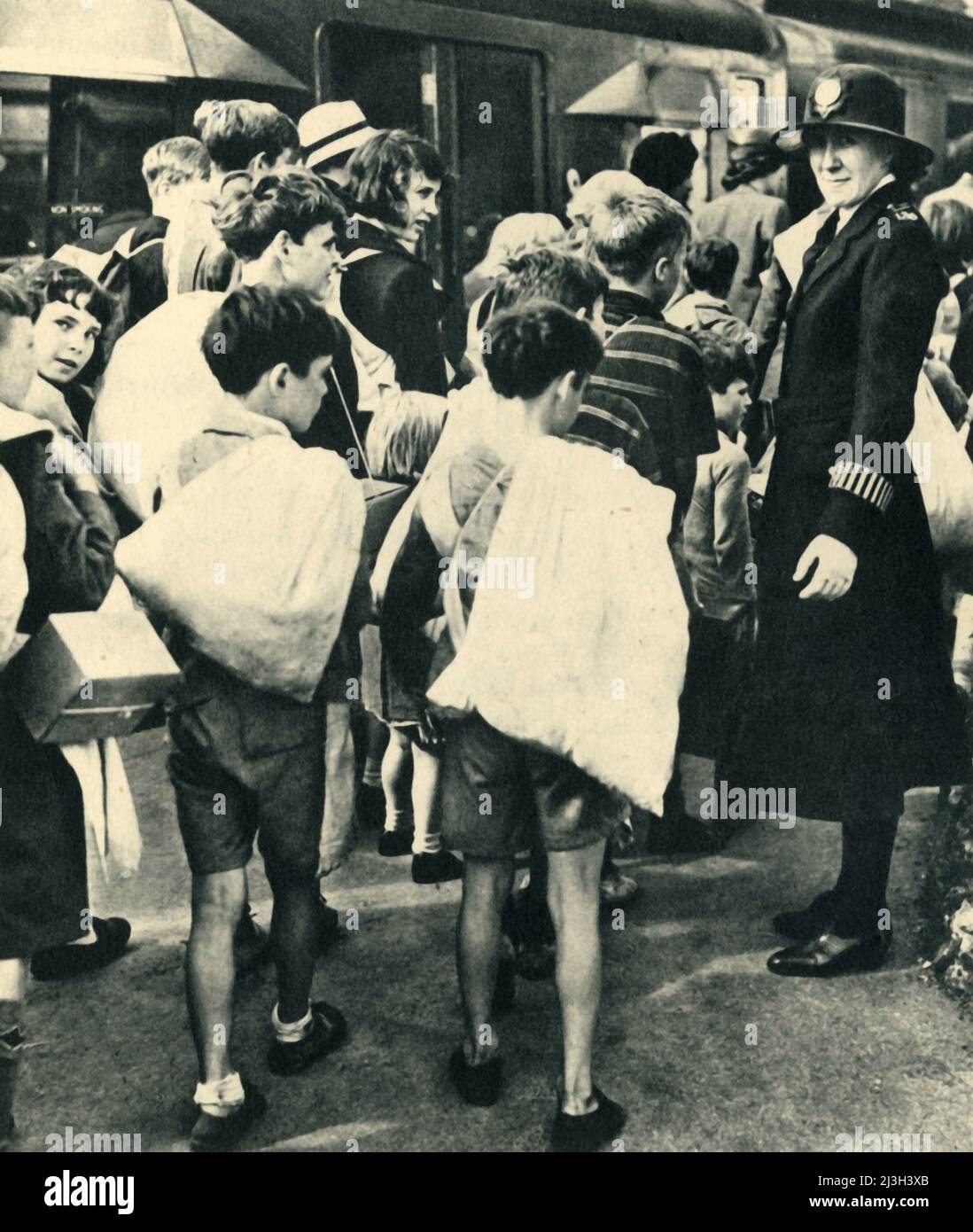'Children Leaving London for the Country', 1943. British evacuees escape bombs during the Second World War. From &quot;Women's Institutes', by Cicely McCall. [Collins, London, 1943] Stock Photo