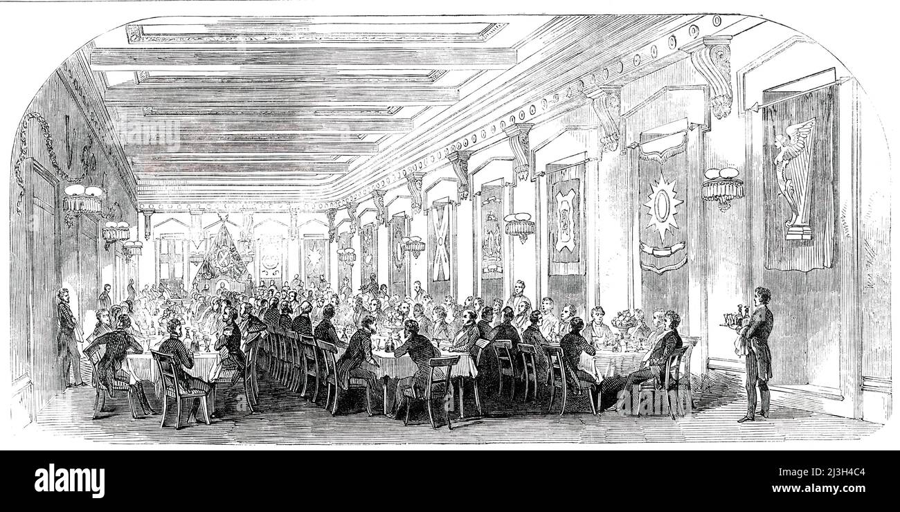 Grand Dinner in the Masonic Hall, at Montreal, 1850. '...the citizens of Montreal [in Canada, decided on] the necessity of preparing a suitable display of Canadian industry, for exposition at the Great Industrial Congress of 1851 [to be held in London. It was therefore] '...decided to hold a Grand Provincial Industrial Exhibition, in the city of Montreal...[A dinner] was given by the Mayor and Corporation of the city, in the beautiful rooms of the Masonic Hall...The room...was tastefully decorated with fanciful devices of evergreens and flowers and the banners of all the national societies wer Stock Photo