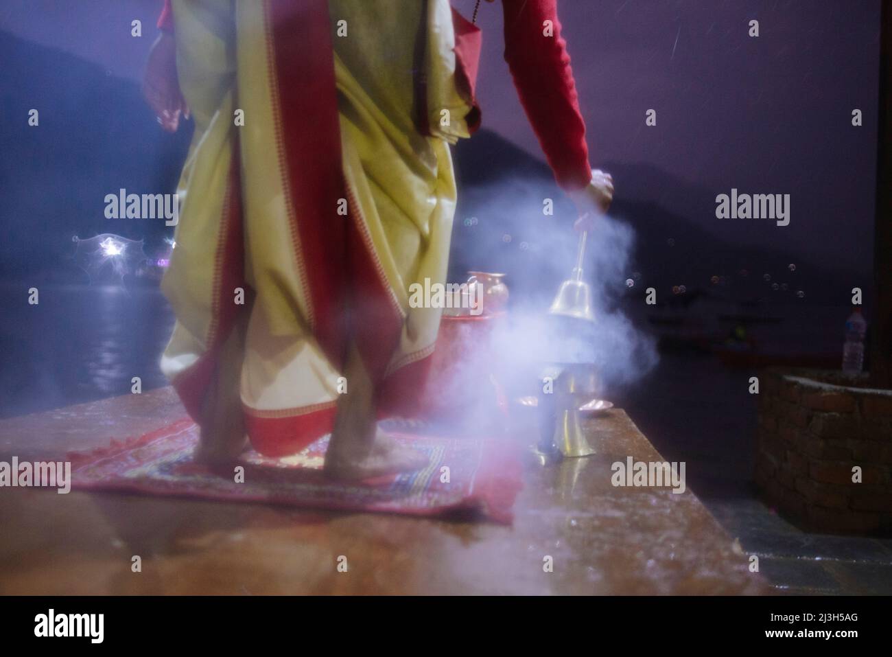 Nepalese Hindu priests perform evening Aarti ceremony during heavy rain ...