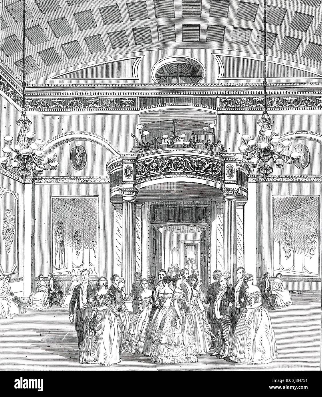 The Whittington Club - New Decoration of the Ball-Room, 1850. The Whittington in Arundel Street, London, formed in 1847, was also a literary institute. 'The splendid ball-room of this Institution has been re-decorated and refitted with great splendour, at a cost of &#xa3;600, the entire amount having been subscribed by the members previous to the commencement of the works...In addition to the decorations, a new orchestra has been erected, which, supported by two graceful and appropriate fluted columns, is cleverly blended with the general character and style of the room, and forms a useful as Stock Photo