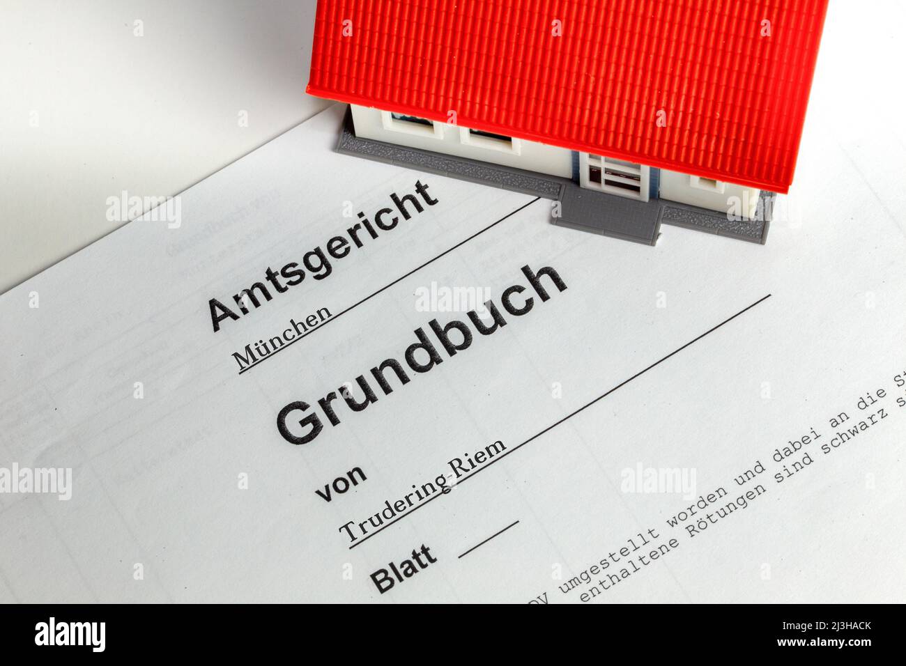Symbol image real estate prices Model house with land register excerpt