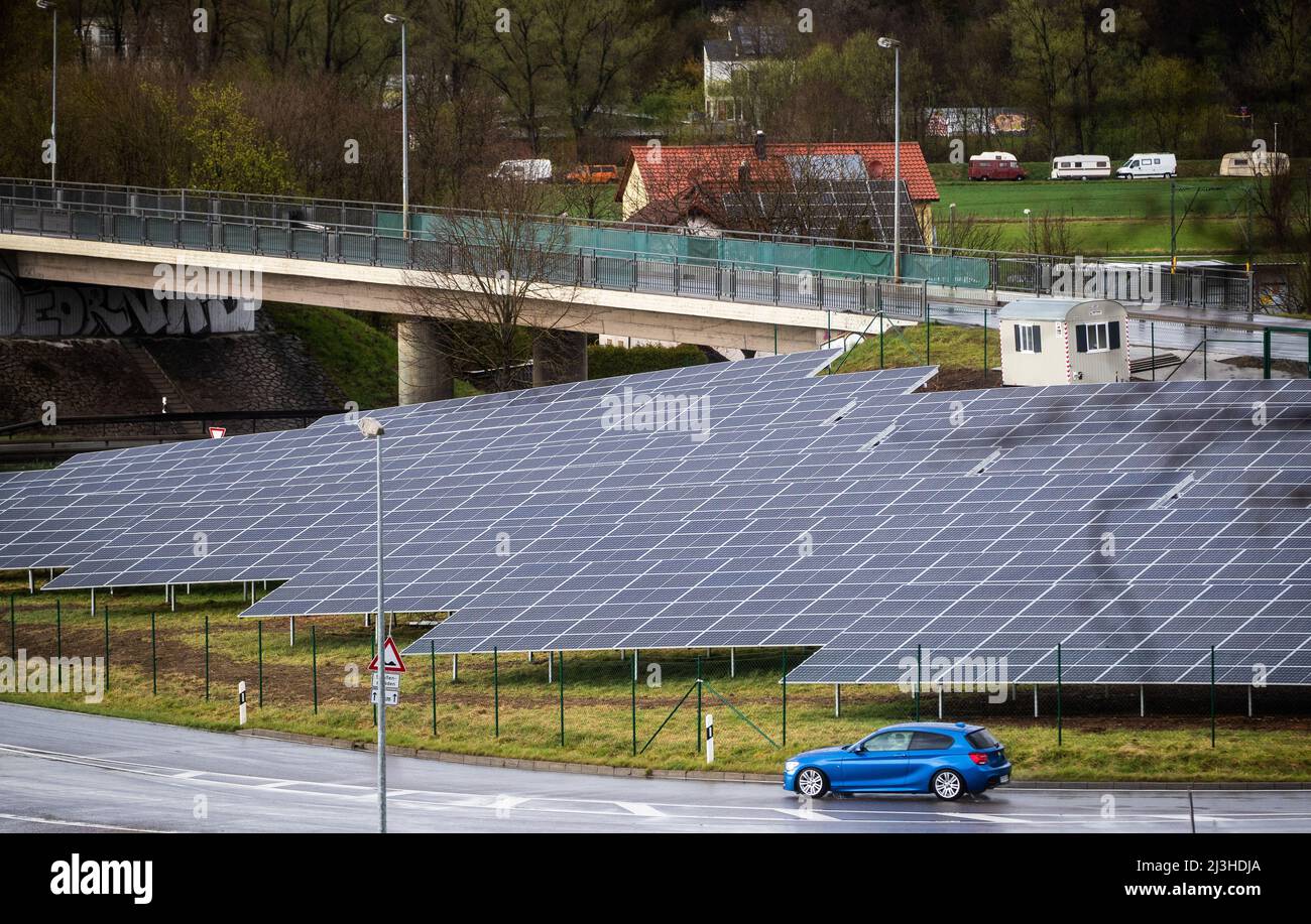 08 April 2022, Baden-Wuerttemberg, Tübingen: A car drives past the 'Lustnauer Ohren' solar park. Photo: Christoph Schmidt/dpa Stock Photo