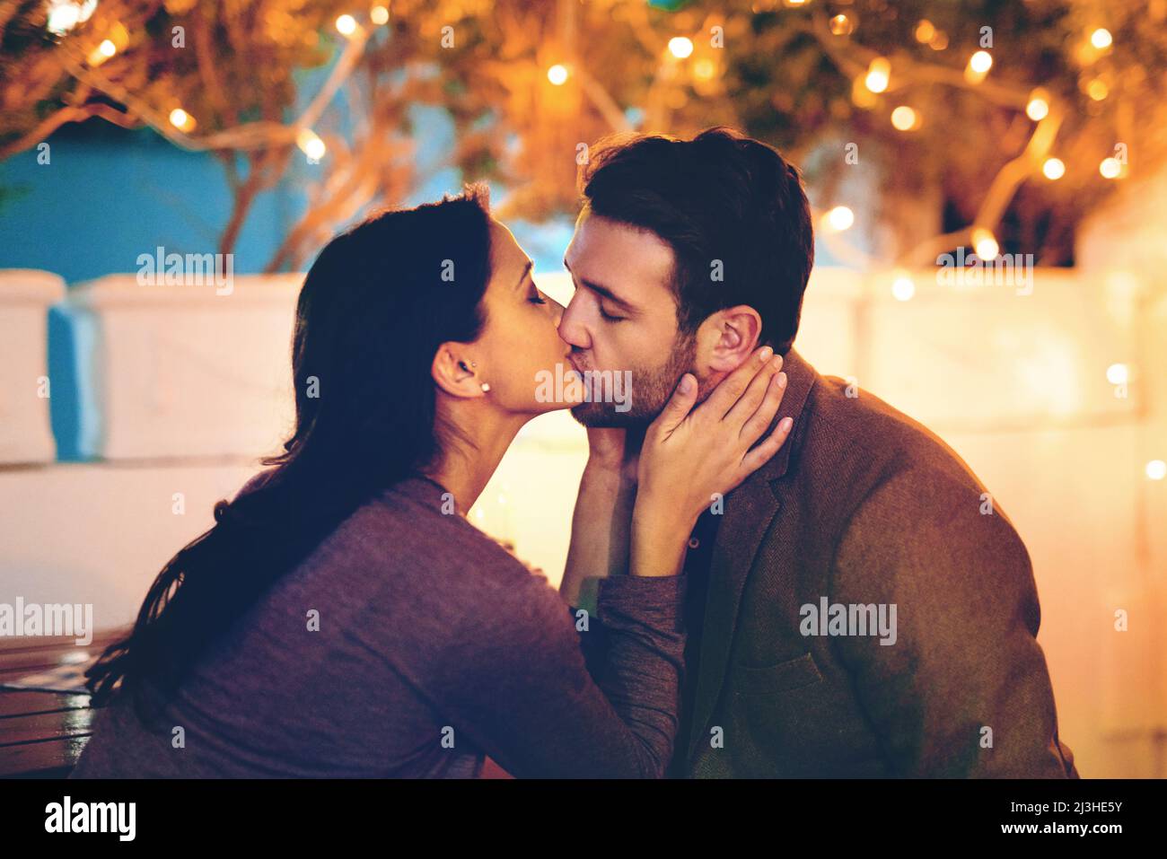 Thank you for a wonderful evening. Cropped shot of an affectionate young couple kissing while having a romantic dinner in a restaurant. Stock Photo