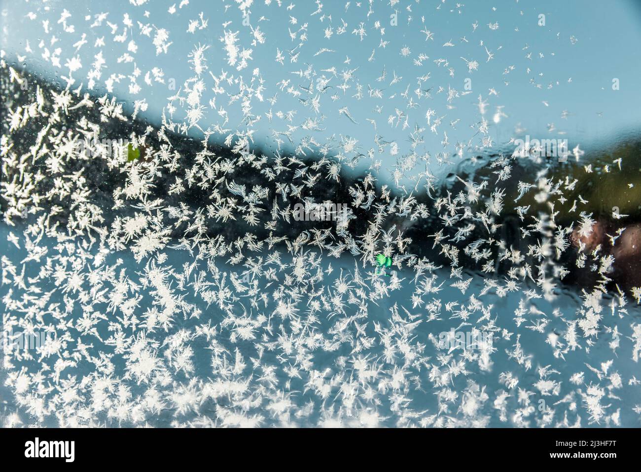 Frozen ice crystals on a window pane in the Rhodope Mountains in Bulgaria Stock Photo
