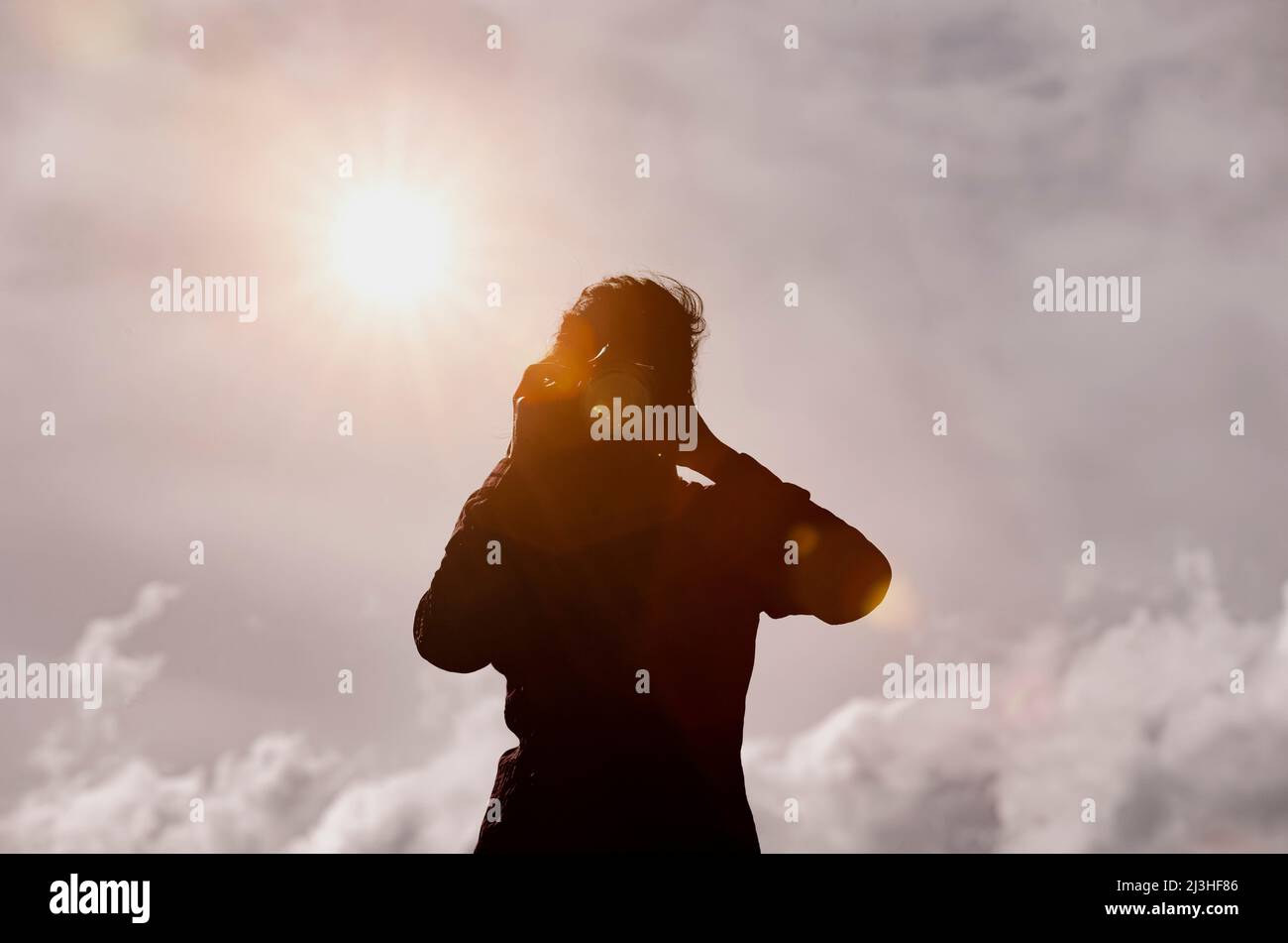 Silhouette of woman taking photo Stock Photo