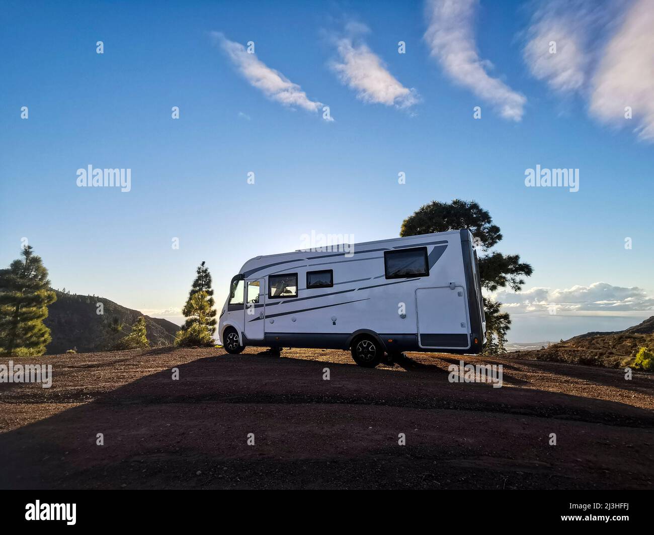 Big camper motorhome parked in off road nature space to enjoy total freedom. Stock Photo