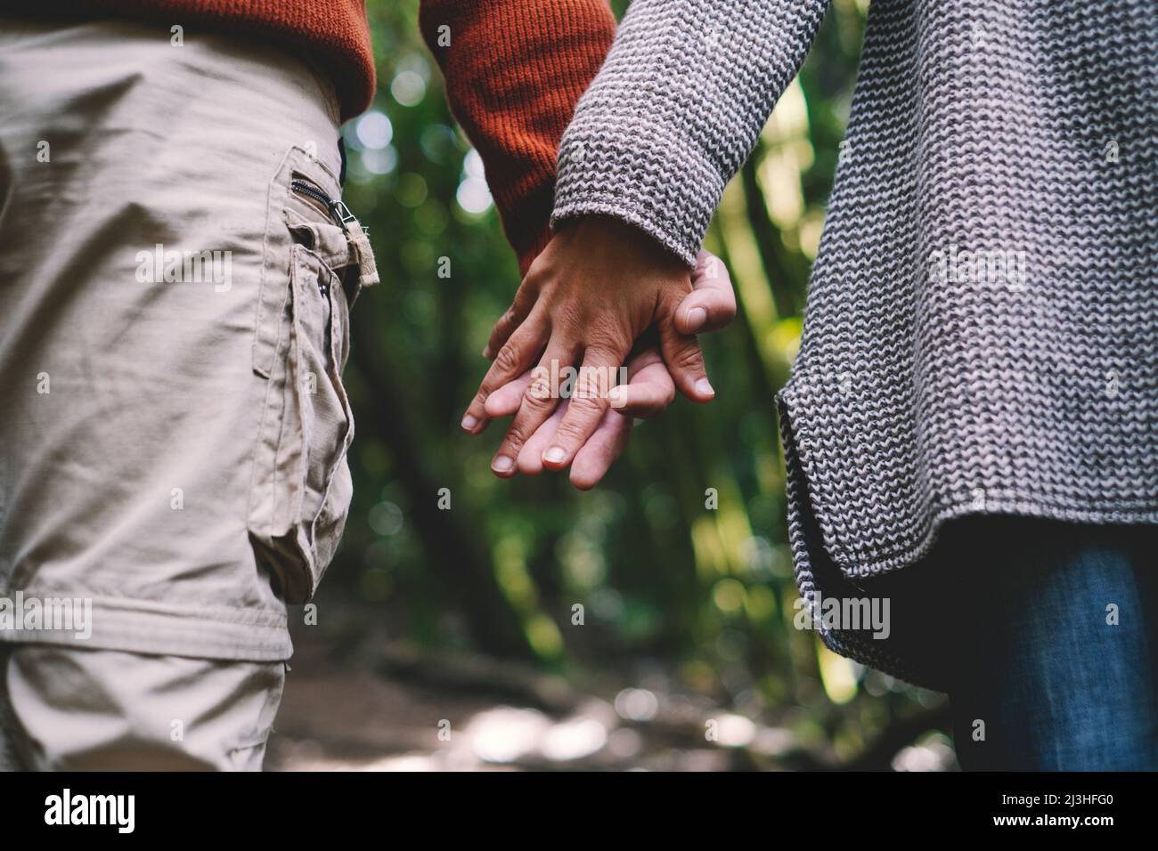 Close up of man and woman, holding hands, walk, Stock Photo
