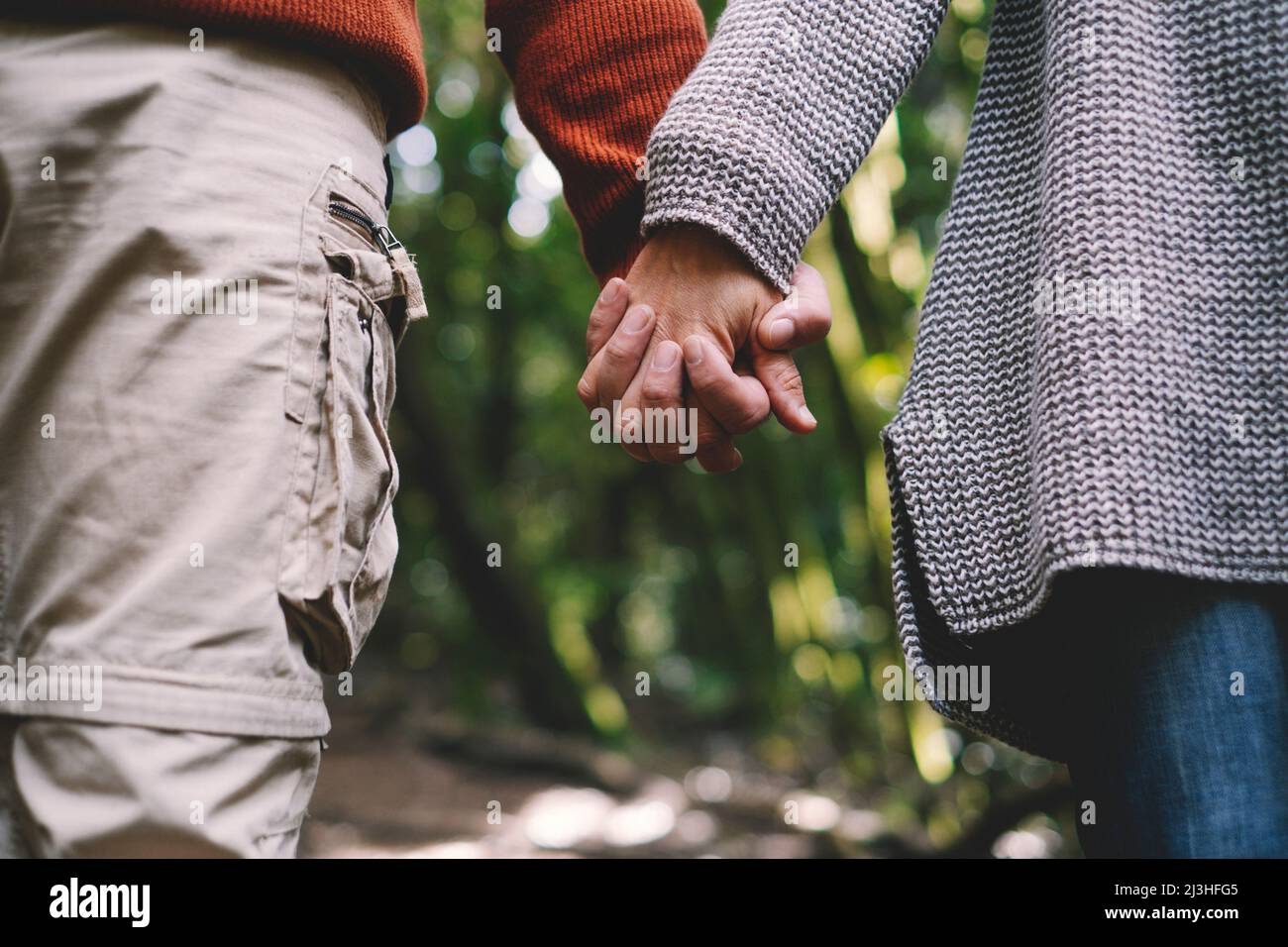 Close up of man and woman, holding hands, walk, Stock Photo