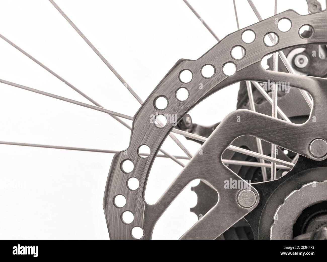 Close up of bicycle with brake disc and spokes in black and white on ...