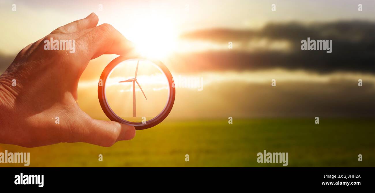 View through a glass with focus on a wind turbine Stock Photo