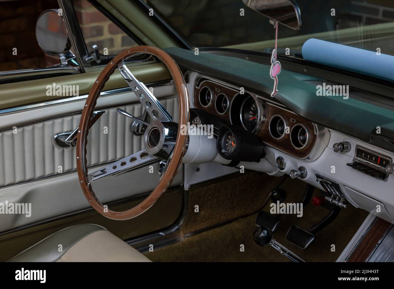Vintage car, brown steering wheel, dashboard, green interior trim, detail Stock Photo
