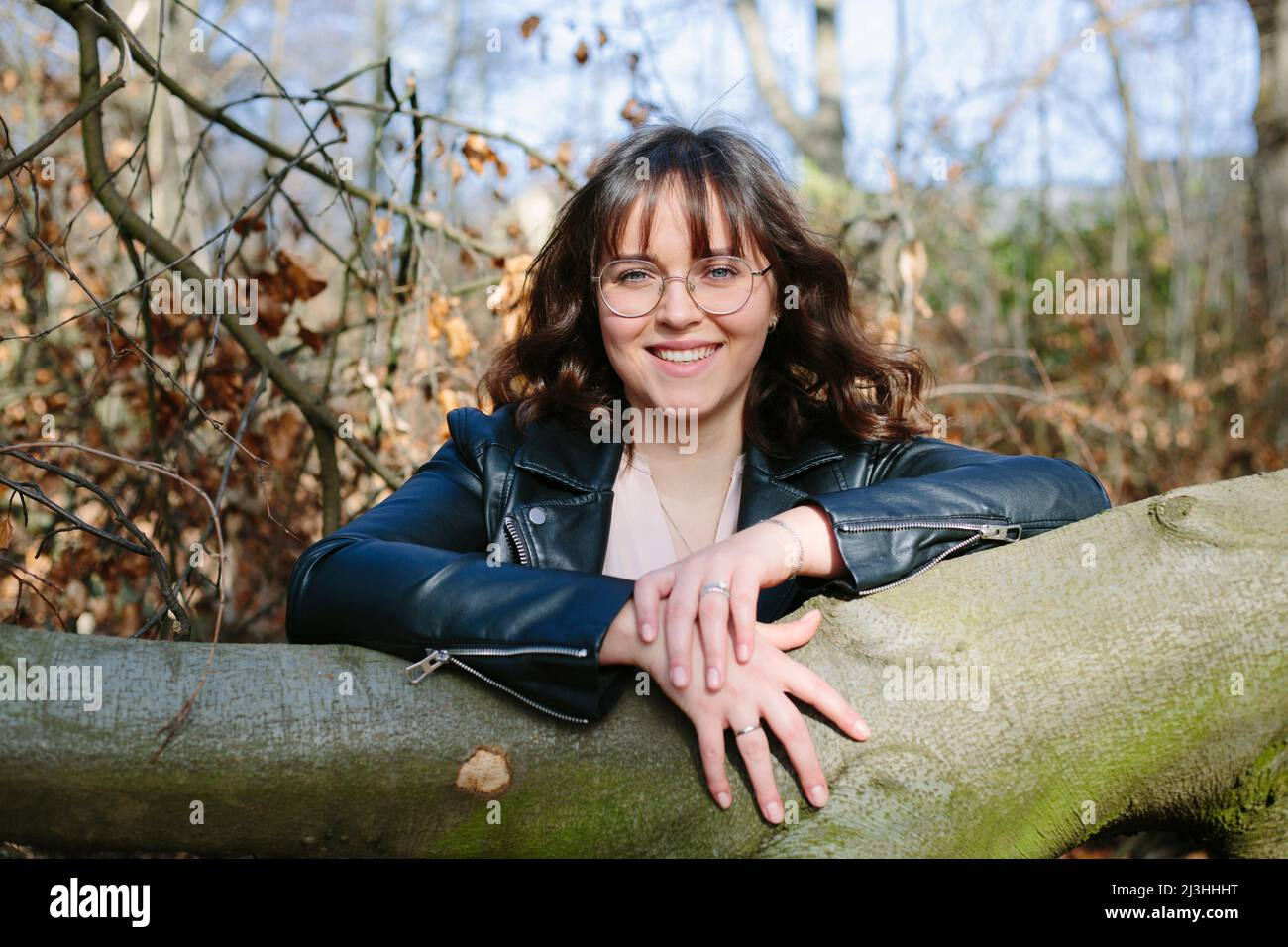 Friendly laughing woman in forest Stock Photo