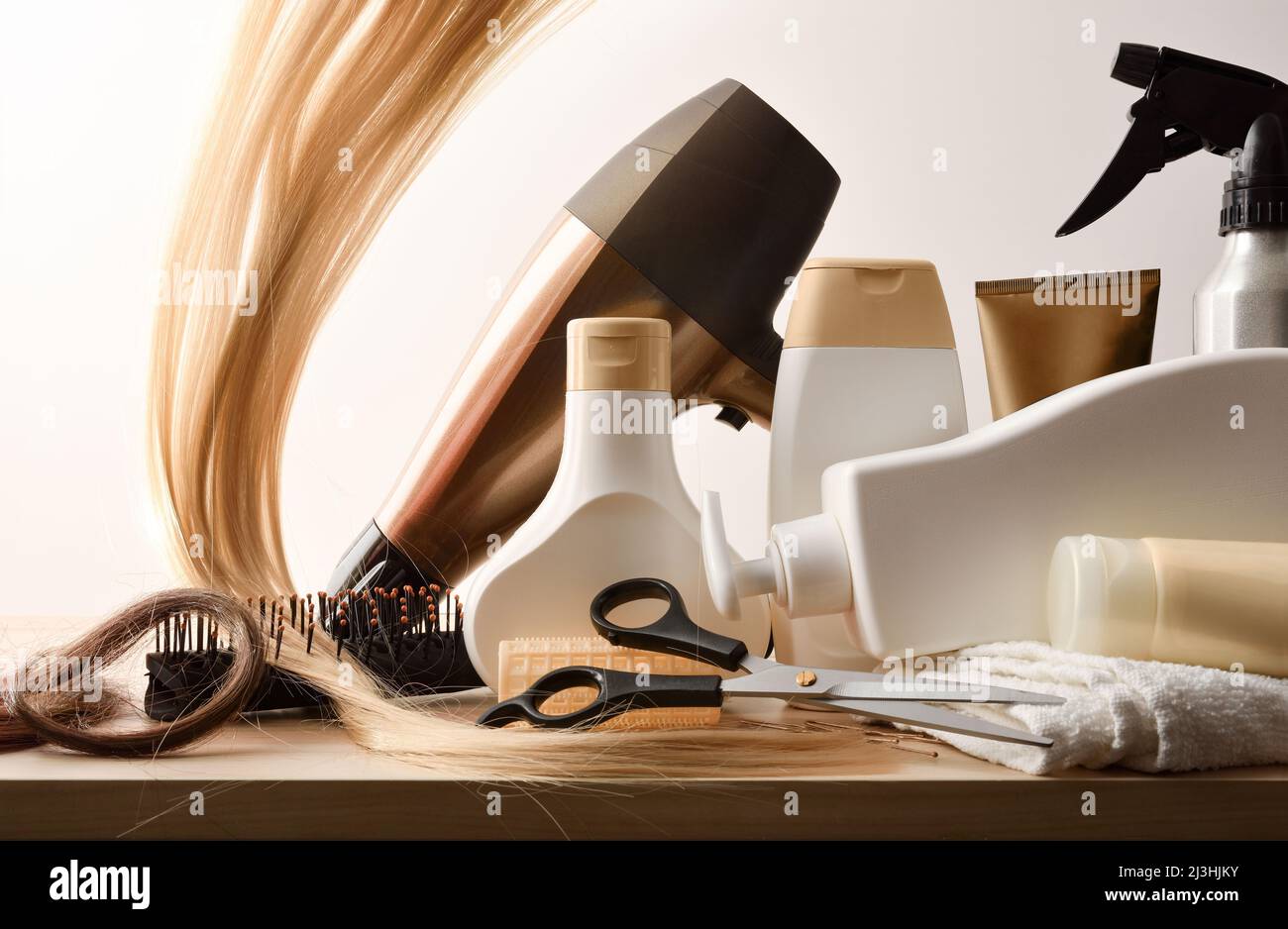 Professional hair stylist products and tools on wooden table and isolated background. Front view. Horizontal composition. Stock Photo