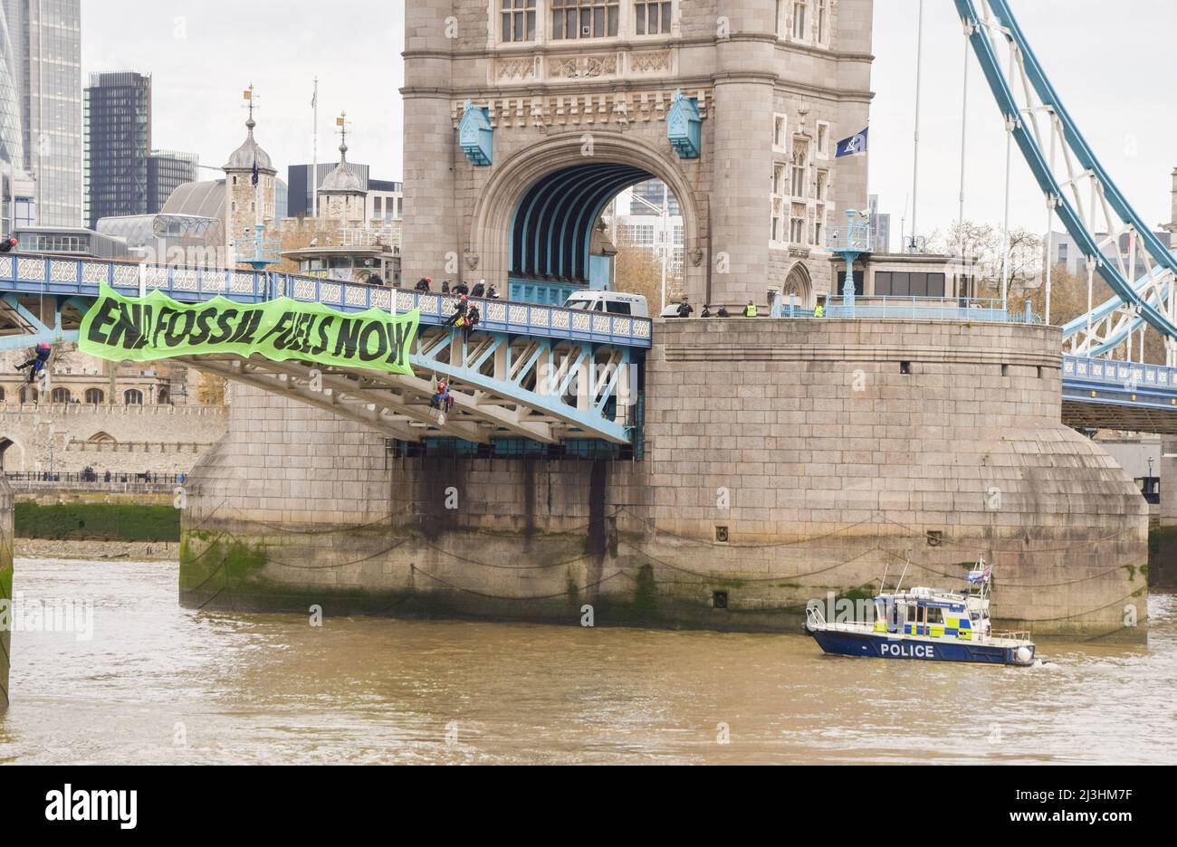 London, UK. 8th April 2022. Extinction Rebellion activists suspended themselves from Tower Bridge and hung a banner in protest against fossil fuels. Stock Photo