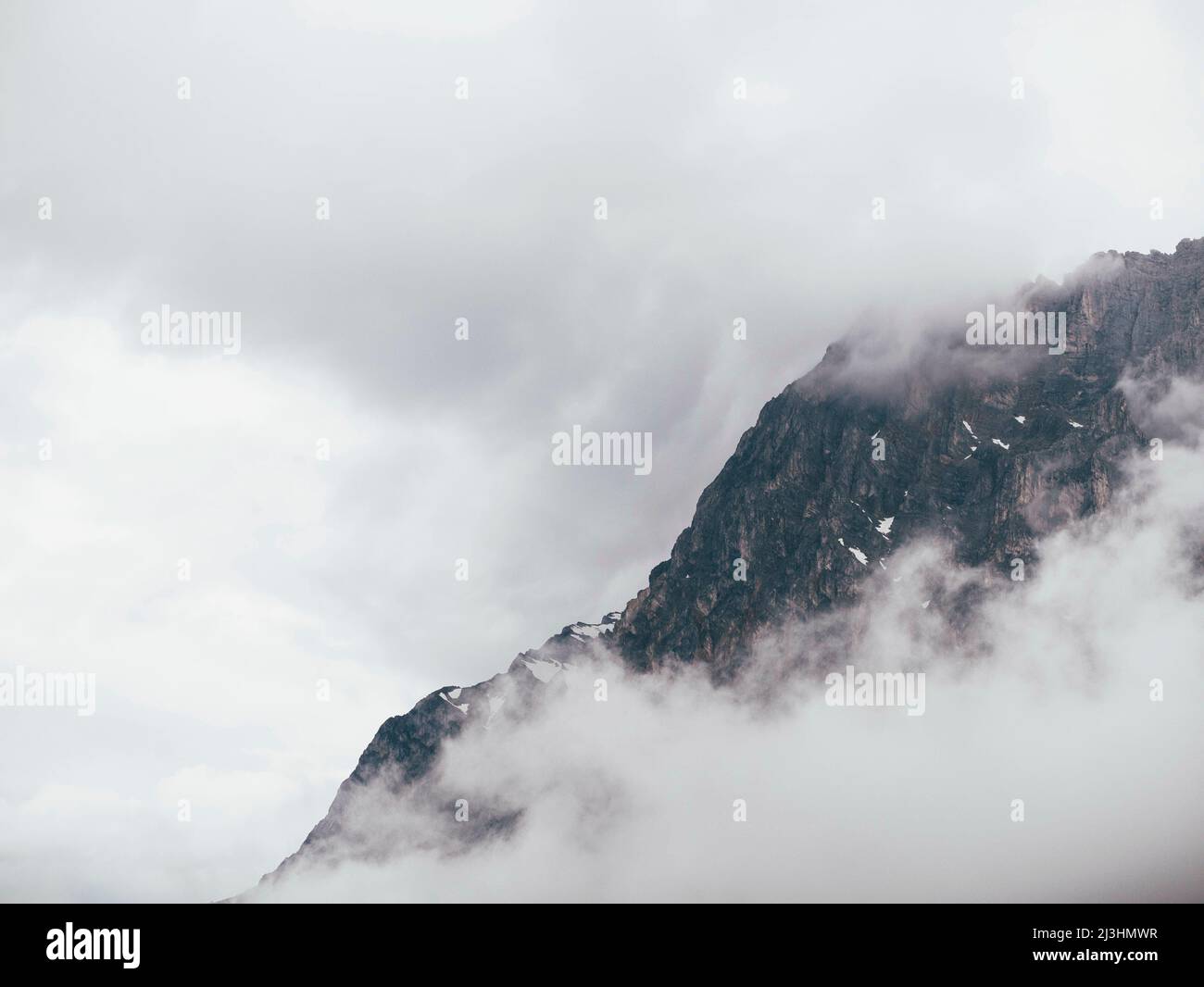 mountainous landscape luring through the clouds Stock Photo