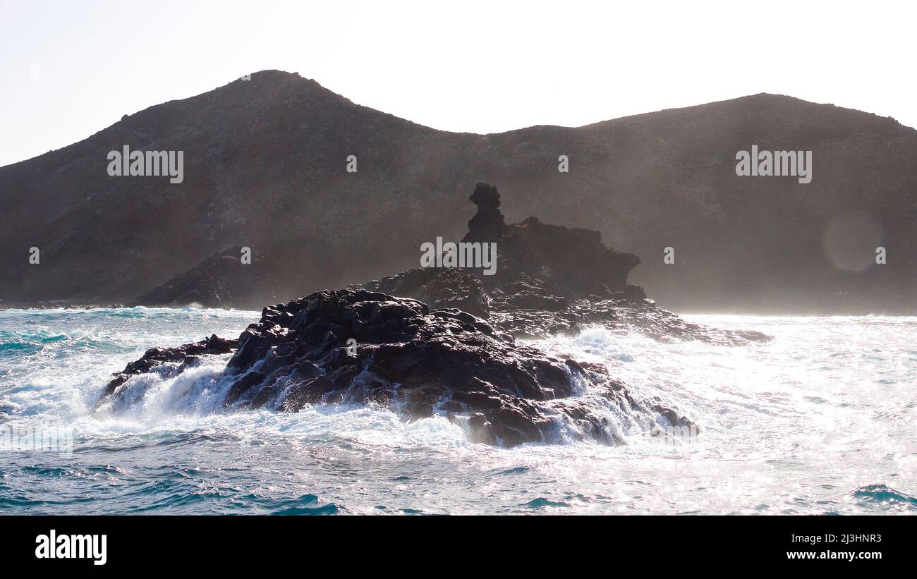 Spain, Canary Islands, Fuerteventura, sailing trip, Los Lobos island, nature reserve, offshore islet is washed over by waves, Los Lobos in background Stock Photo
