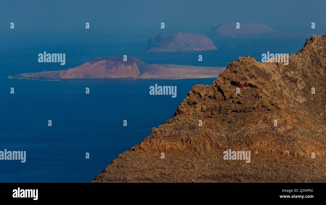 Canary Islands, Lanzarote, volcanic island, northwest coast, hermitage, church, Ermita de las Nieves, sky blue, view from the Ermita to the islands in the northwest a.o. La Graciosa, in the foreground cliff edge Stock Photo