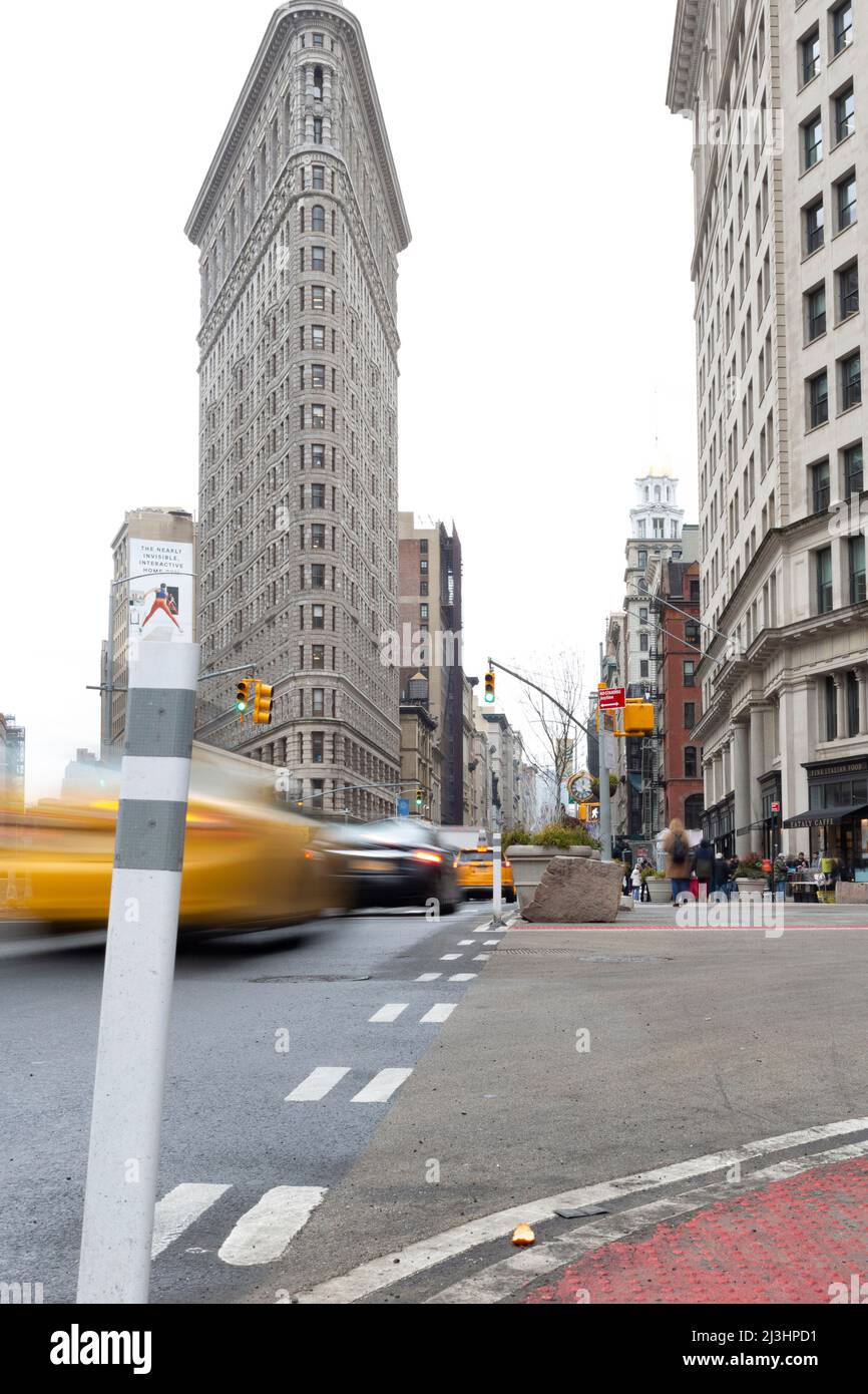 Flatiron Public Plaza, New York City, NY, USA, Slow-shutter shot of the Historic Flatiron or Fuller Building. This iconic triangular building located in Manhattan's Fifth Ave was completed in 1902. Stock Photo