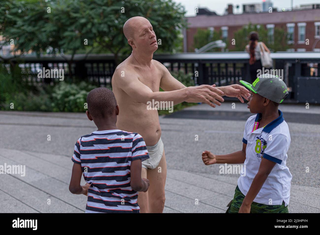 Chelsea, New York City, NY, USA, Exhibition 'Wanderlust' at the High Line (a popular linear park built on the elevated train tracks above Tenth Ave). In Focus, Tony Matelli's 'Sleepwalker', a hyperreal sculpture of an old man staggering about in his saggy white briefs. Stock Photo