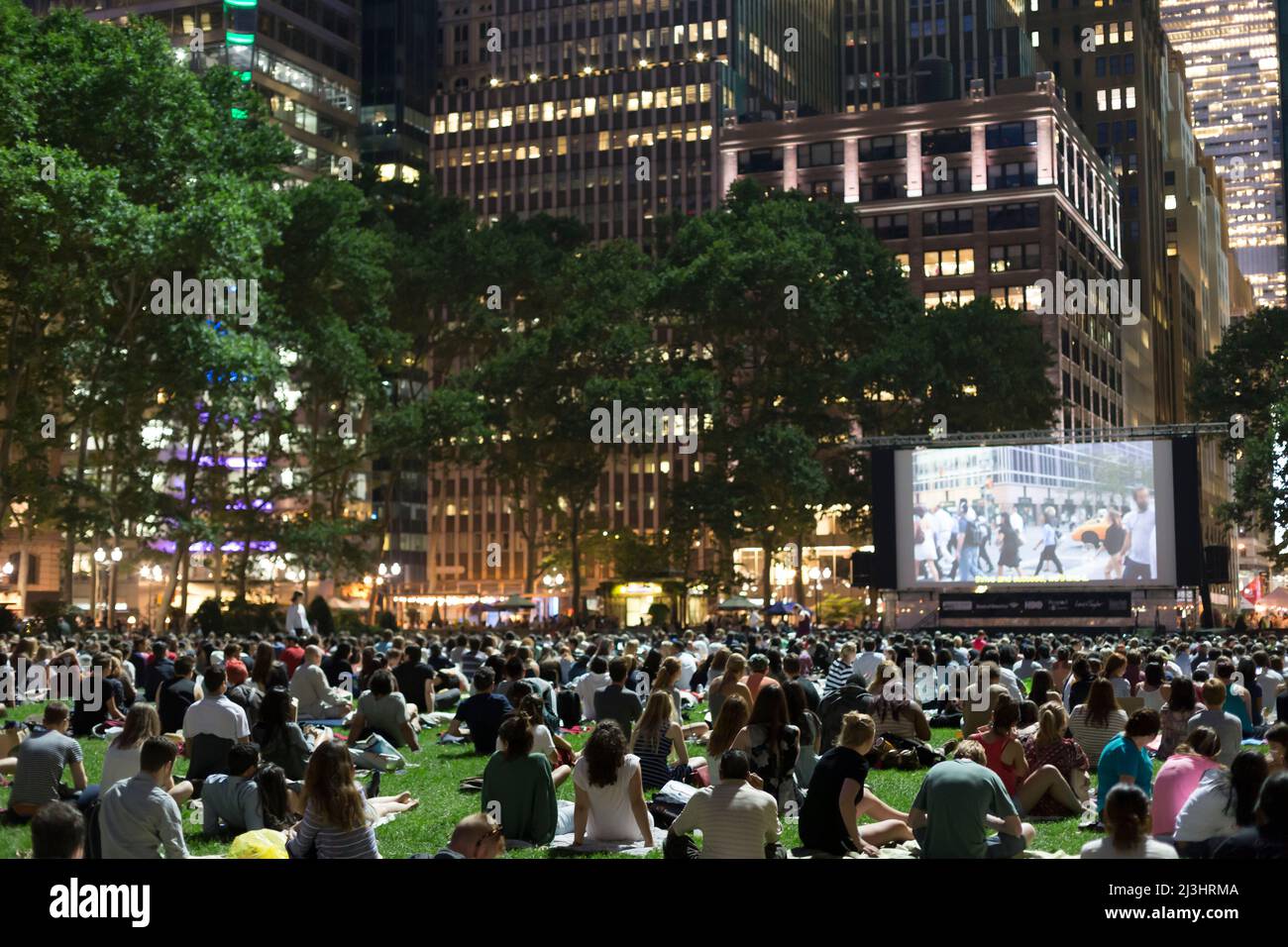 Newyorkers and tourists enjoying the bryant park summer film festival
