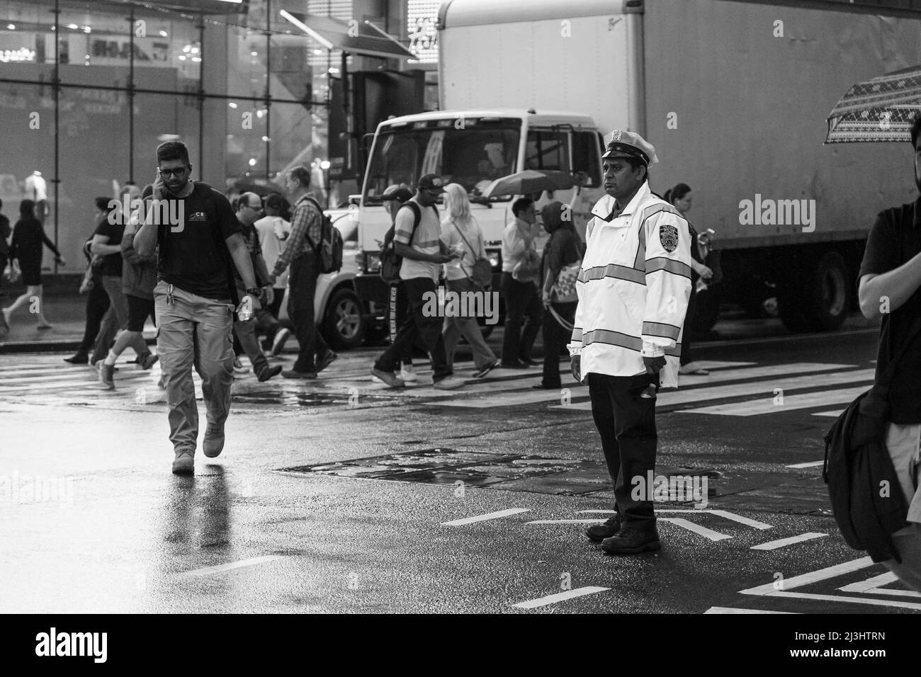 TIMES SQ - 42 Street, New York City, NY, USA, NYPD Police officer regulating the traffic Stock Photo