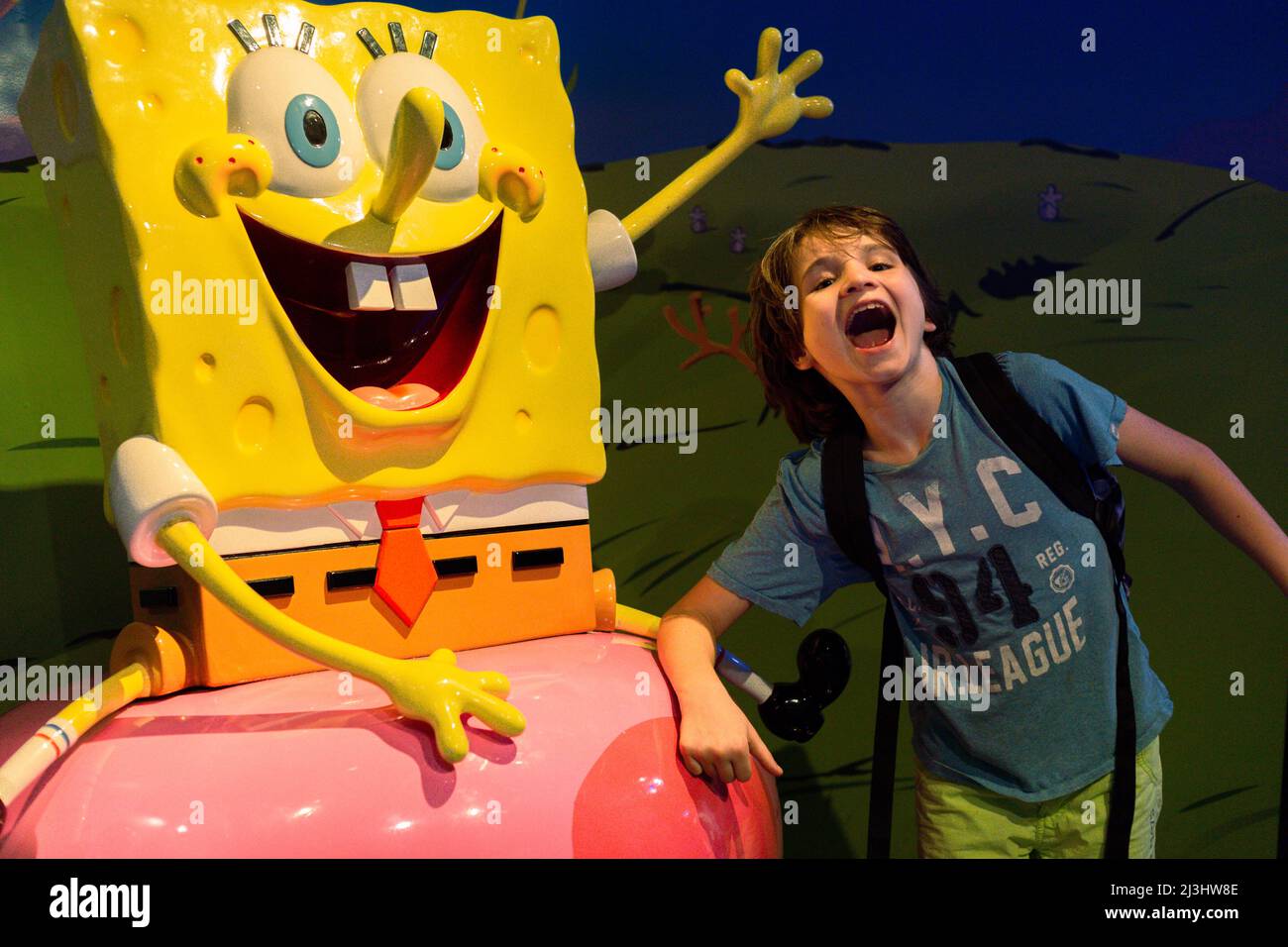 Theater District, New York City, NY, USA, 12 years old caucasian teenager boy - with brown hair and in summer outfit with Sponge Bob at Madame Tussauds Stock Photo
