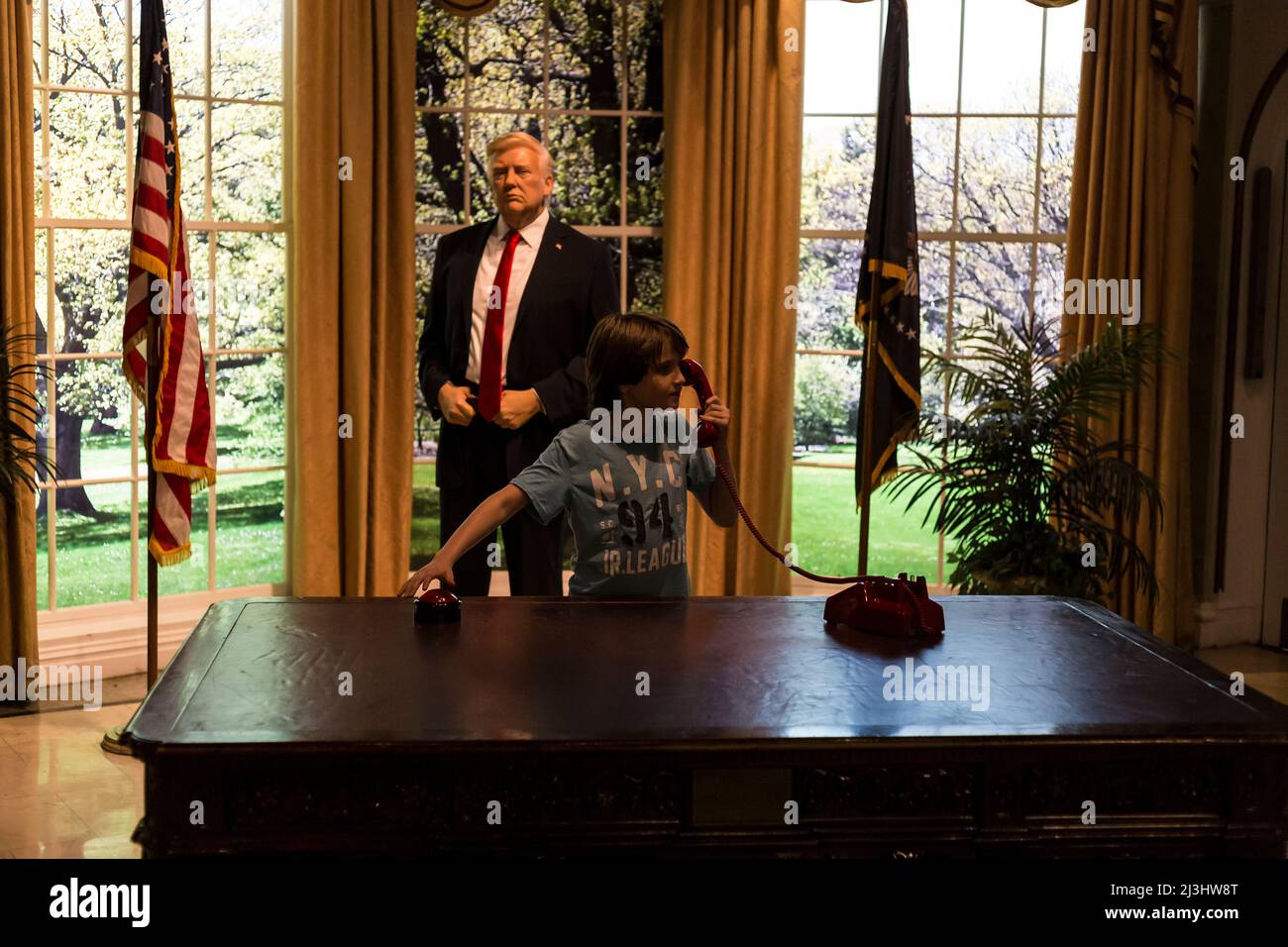 Theater District, New York City, NY, USA, 12 years old caucasian teenager boy - with brown hair and in summer outfit with Donald Trump at the oval office at Madame Tussauds Stock Photo