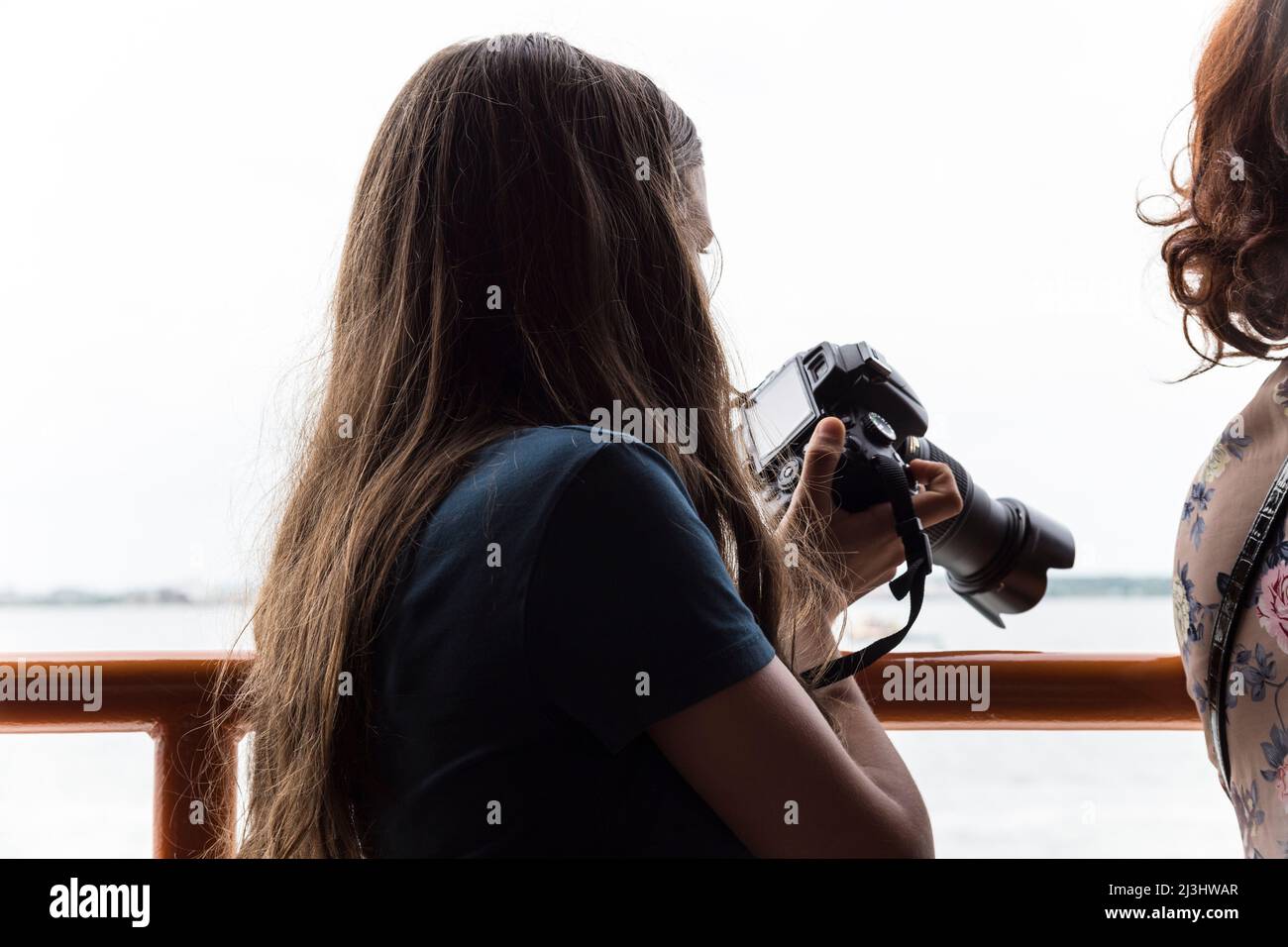 BROOKLYN, New York City, NY, USA, 14 years old, caucasian teenager girl with brown hair preparing the next Shot on the ferry Stock Photo