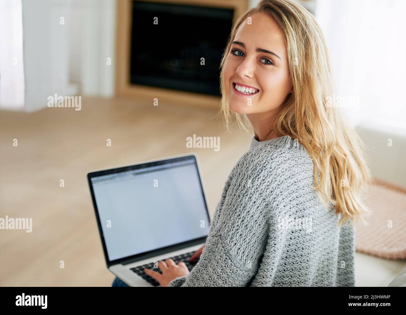 Blogging is great. High angle portrait of an attractive young woman using her laptop at home. Stock Photo