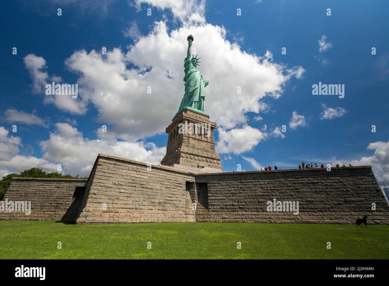 Liberty Island, New York City, NY, USA, Statue of Liberty and a dramatic sky Statue of Liberty against blue sky with beautiful cloud background Stock Photo
