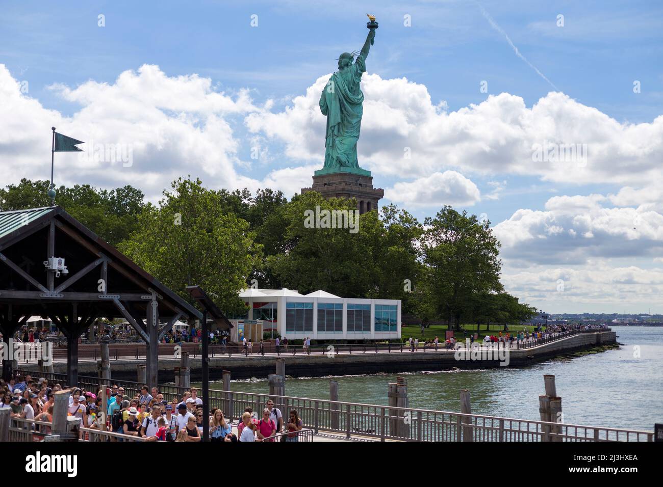 LIBERTY ISLAND FERRY, New York City, NY, USA, Statue of Liberty and a dramatic sky Statue of Liberty against blue sky with beautiful cloud background Stock Photo