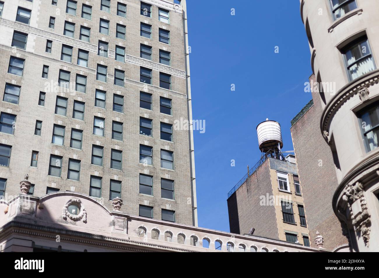 NOMAD, New York City, NY, USA, A water tank on roof of apartment building in New York City hold water that is sourced from the Catskill Mountains Stock Photo