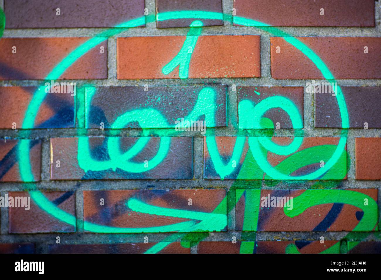 Colorful graffiti on a wall, writing Love Stock Photo