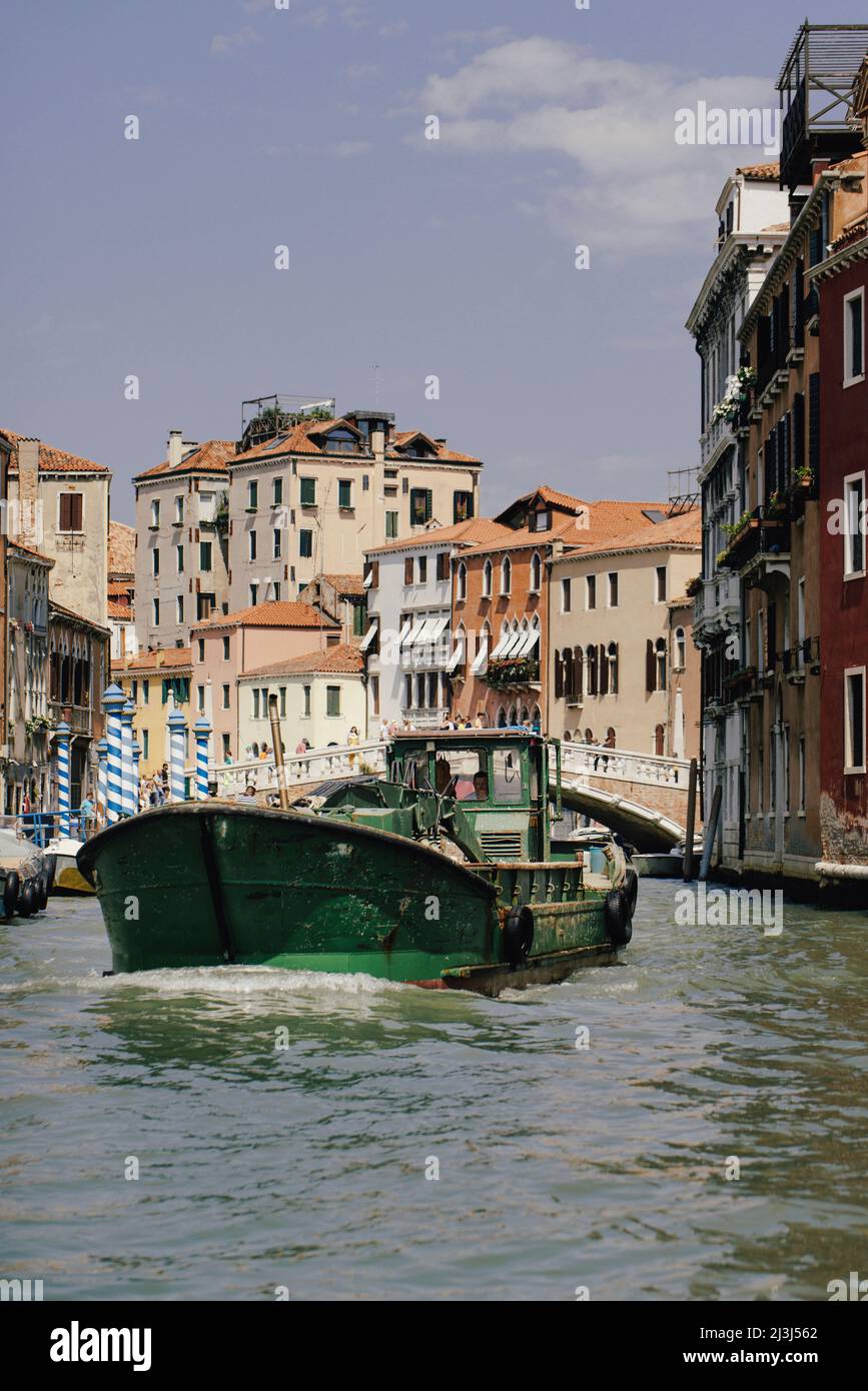 Commercial vehicle traveling on a canal in Venice, Italy Stock Photo