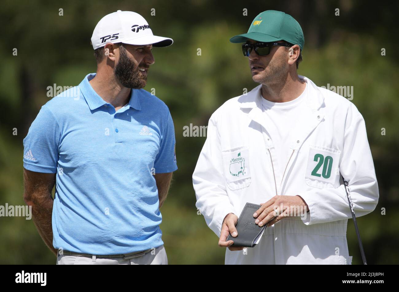 Augusta, USA. 08th Apr, 2022. Dustin Johnson talks with his caddie and brother Austin Johnson on