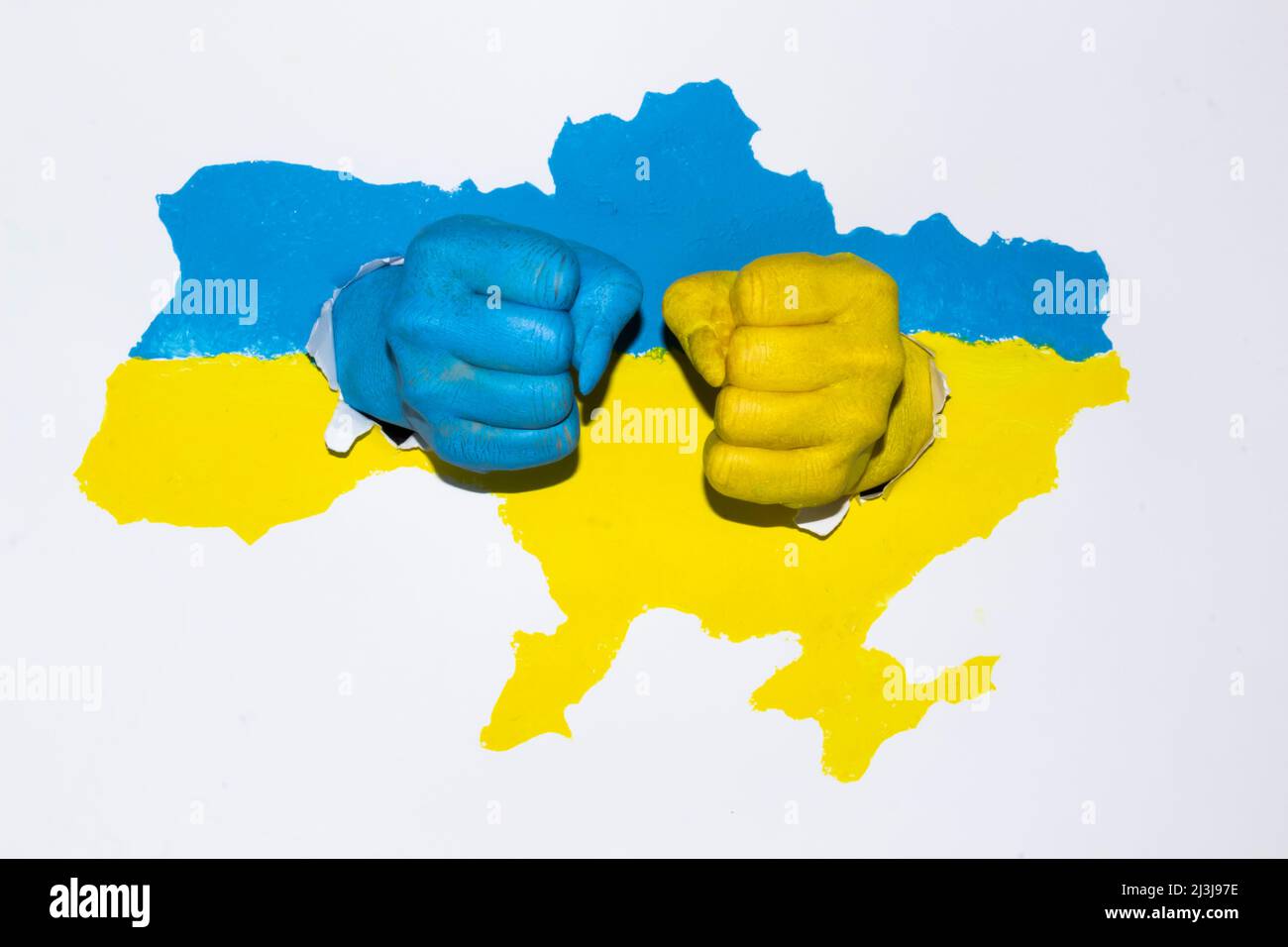 Drawing map of Ukraine in blue yellow color with female hands ready to fight. Ukraine is strong. Female fists painted in color with flag of Ukraine. Stock Photo