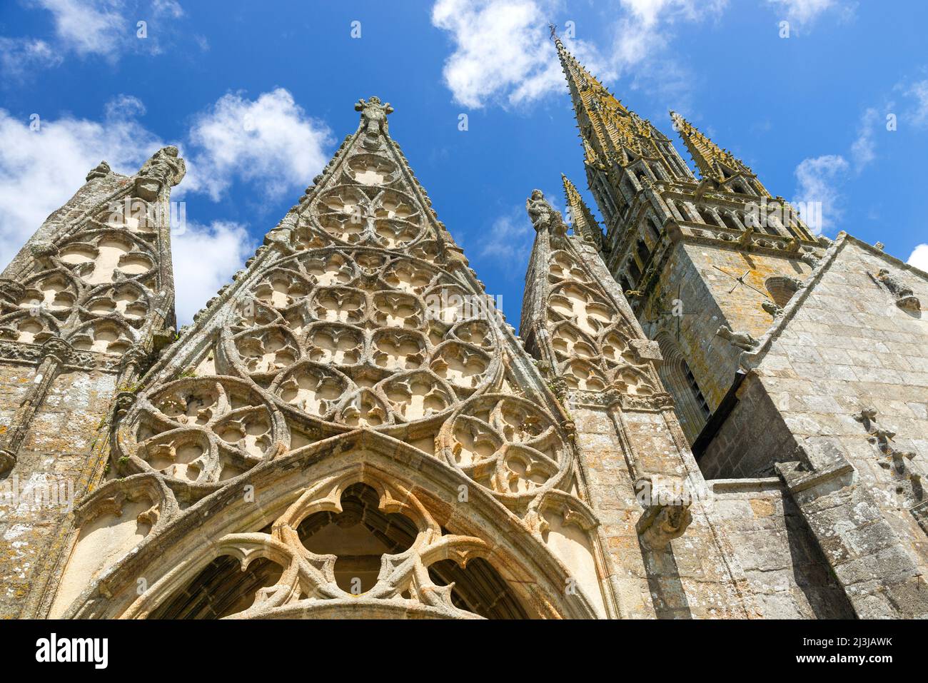 Church 'Notre-Dame-de-Roscudon' in Pont-Croix, gable of the porch decorated with rosettes in flamboyant Gothic and granite stone bell tower, Monument historique, France, Brittany, Département Finistère Stock Photo