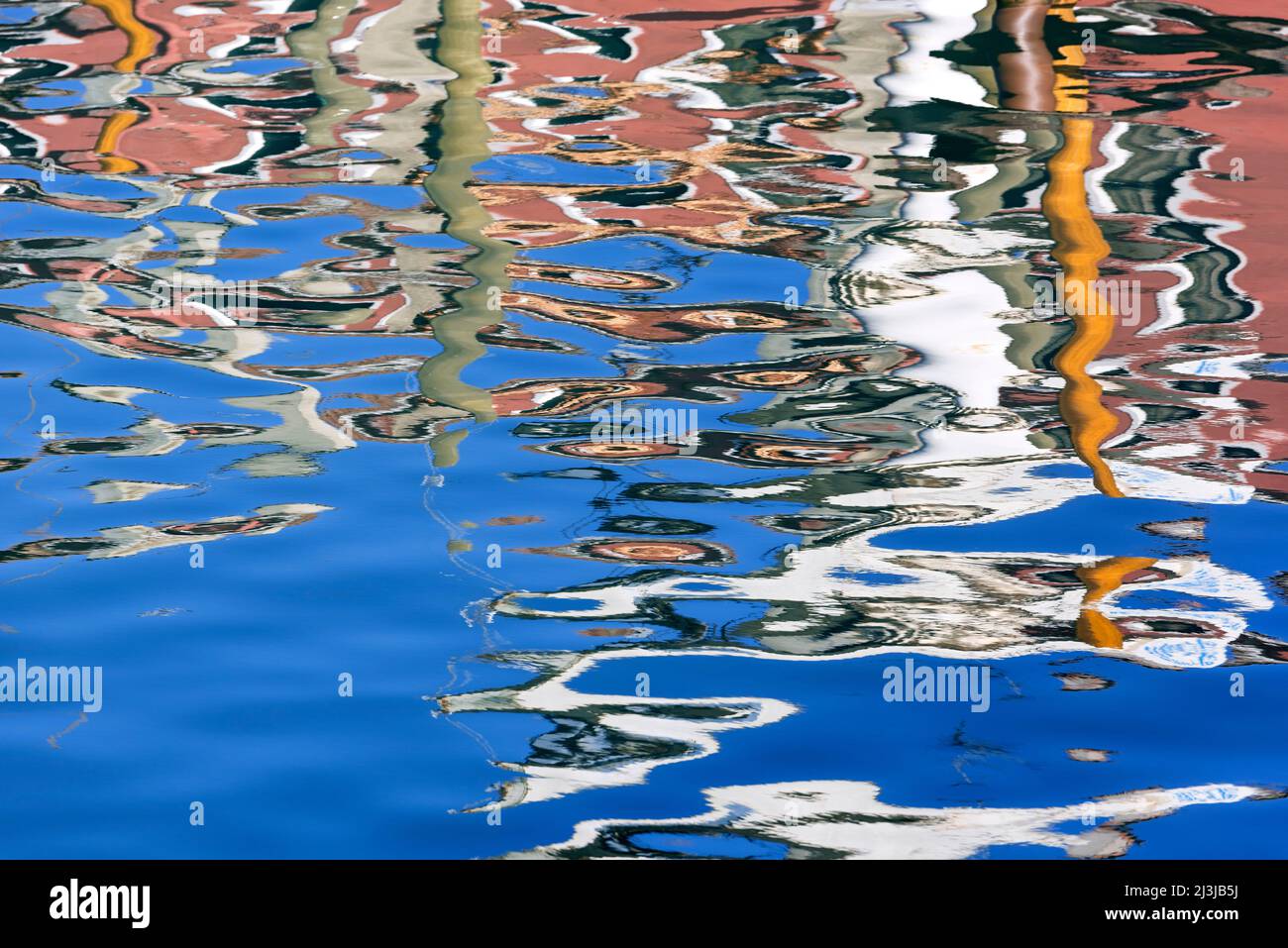 colorful house facades reflected in the water, Italy, Veneto, Venice ...