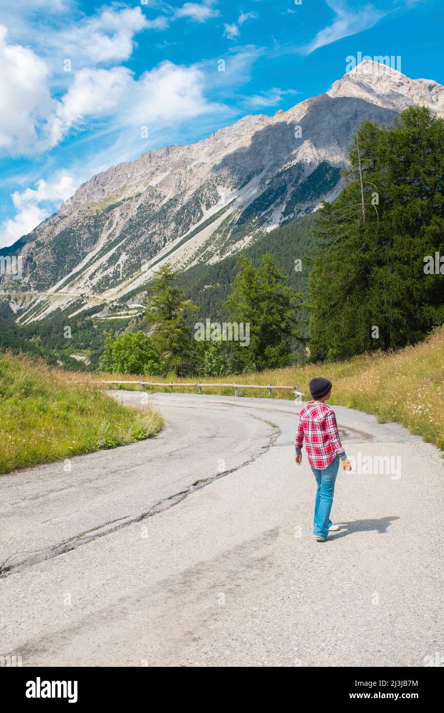 Mountain tourist outdoor leisure activity concept. Woman looking the sky. Tourism and tourist summer holiday vacation. Country side freedom and activi Stock Photo