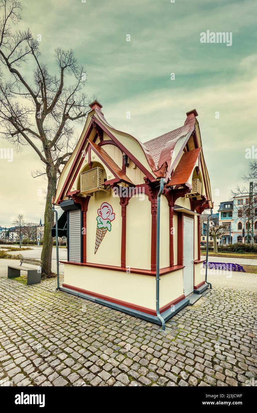 Rhine promenade near Bingen in winter, abandoned ice cream parlor in neat wooden house, sky with evening atmosphere Stock Photo