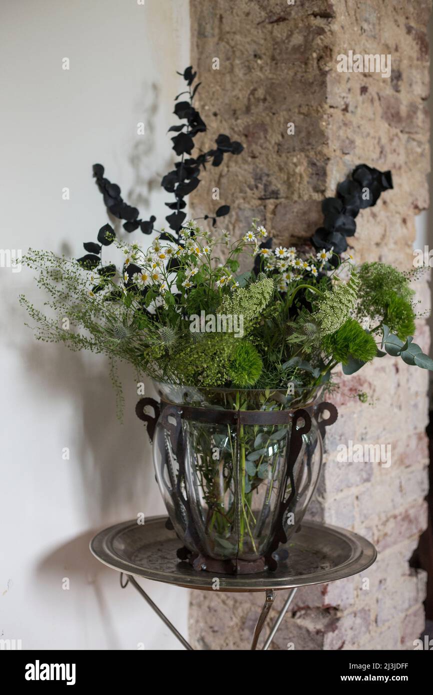 Modern bouquet of flowers in a decorative glass vase on an order table