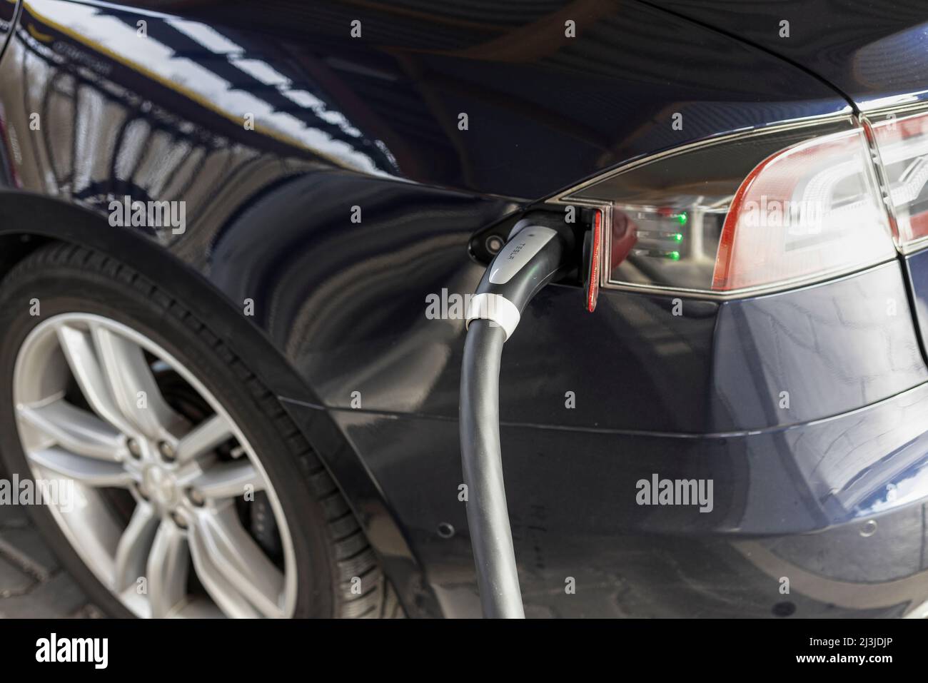 Detail of a Tesla charging at a Supercharger station in Germany Stock
