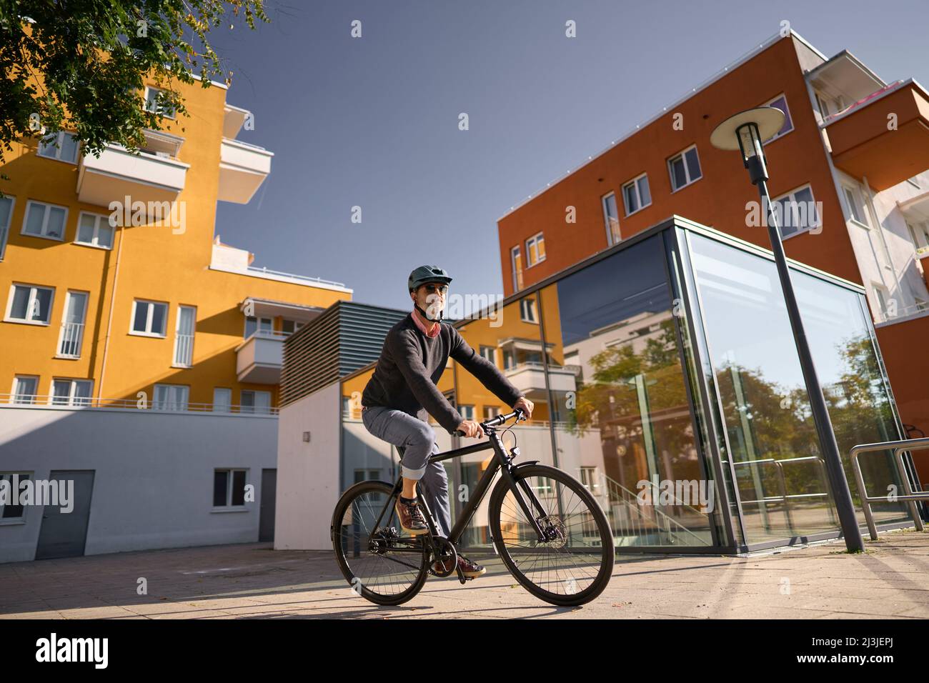 middle-aged man on bicycle, urban, Munich, Germany Stock Photo