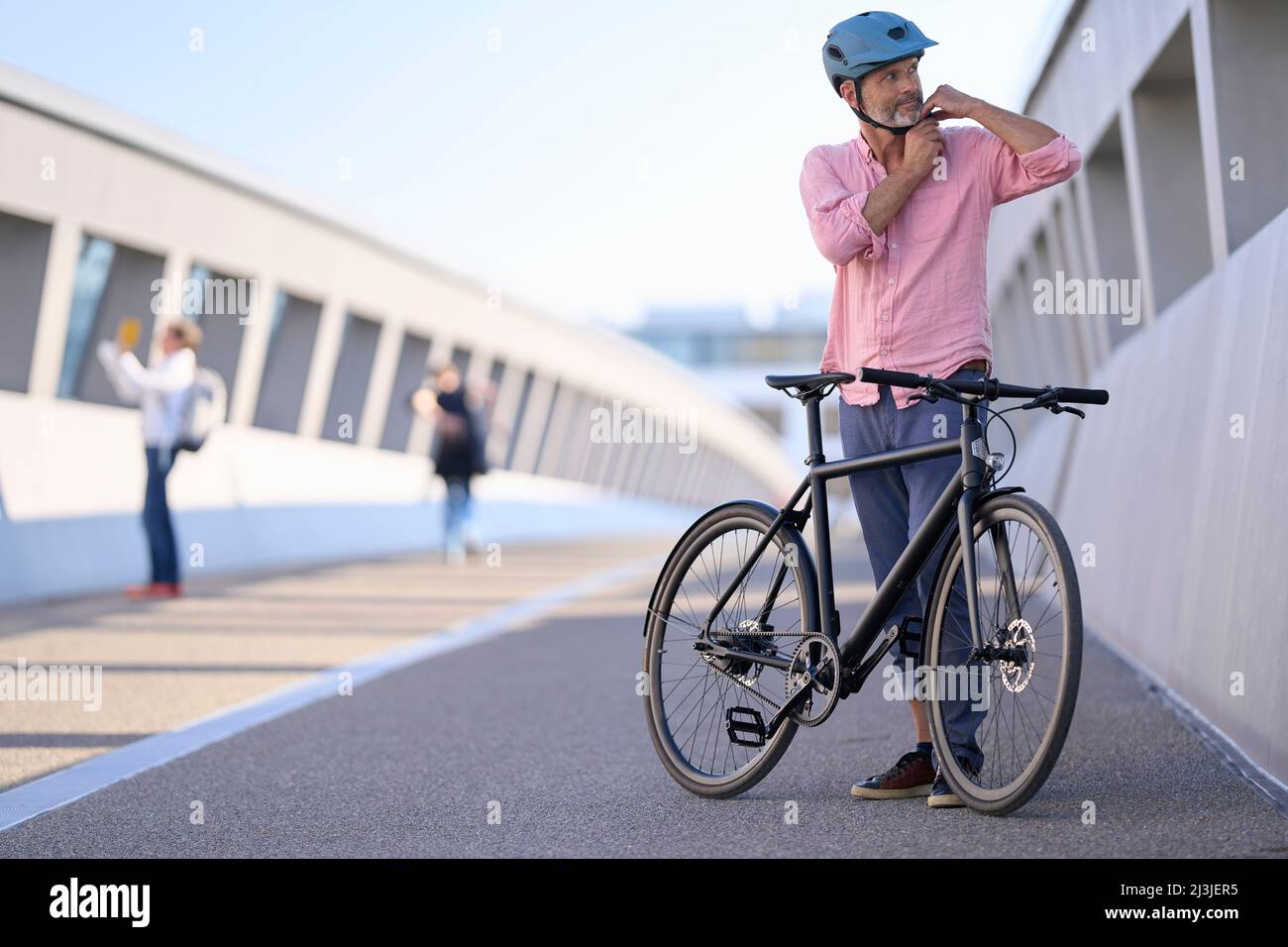middle-aged man on bicycle, urban, Munich, Germany Stock Photo