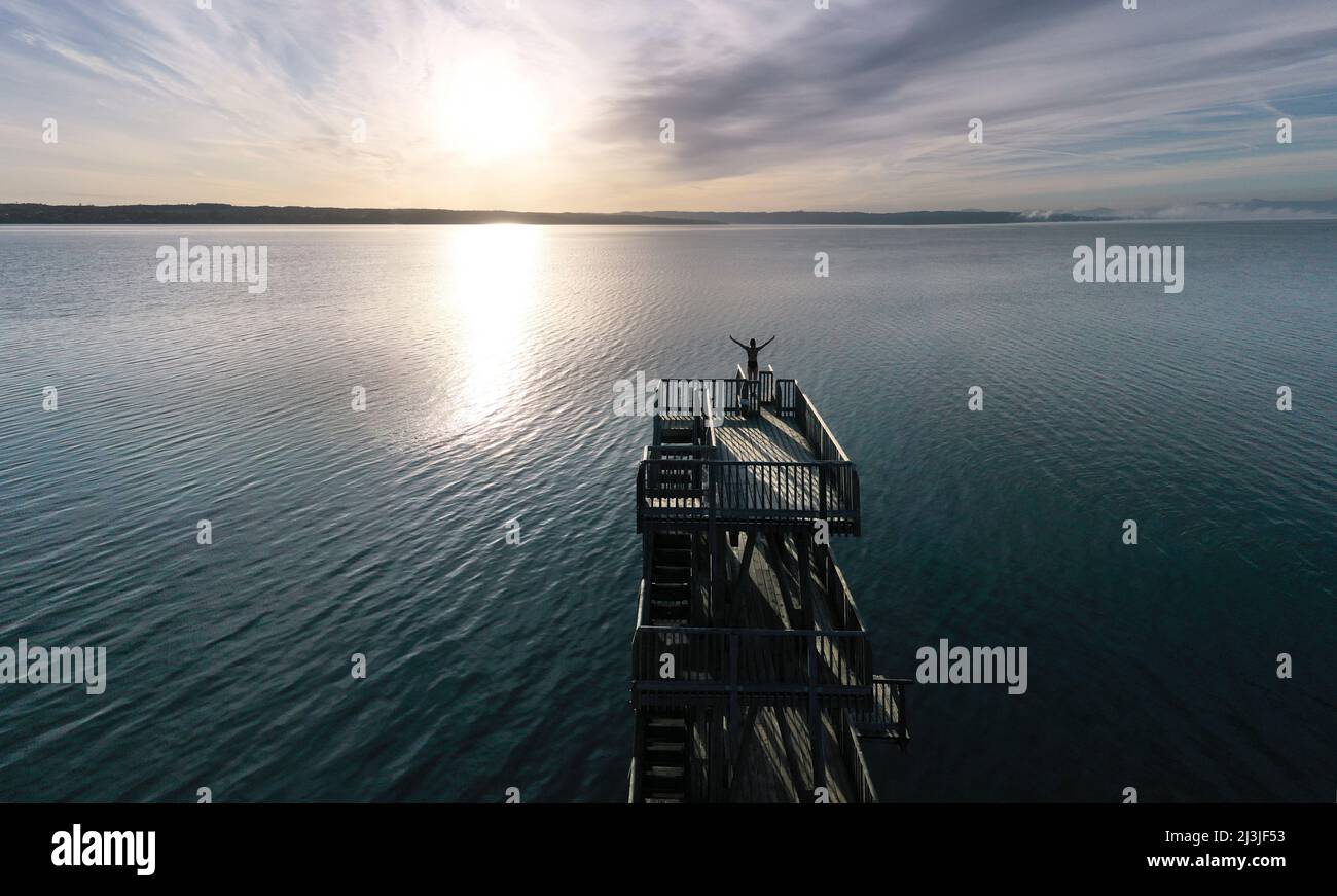 Woman on diving tower at lido Utting am Ammersee, Bavaria, Germany Stock Photo