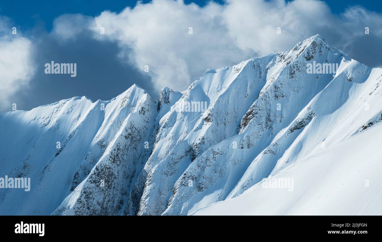 The Pfeilspitze is a wild grass mountain above Lechtal. In winter, its sharp and steep ridges and flanks are snow-covered and resemble more an Andean or Himalayan giant than a grassy mountain in the Northern Limestone Alps. Stock Photo