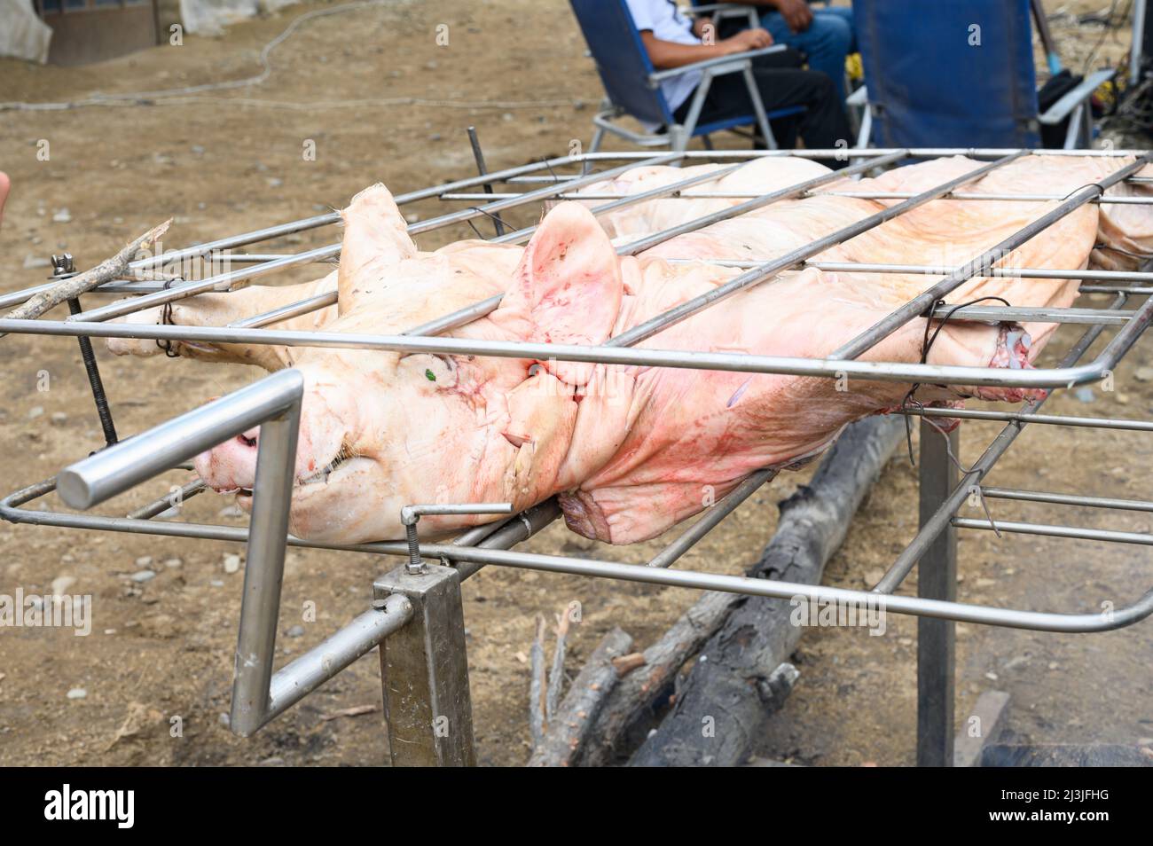 Grilled pig at the street food festival. Roasted pig on the rack. Food Stock Photo